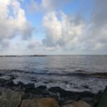 Image of the sea and rocky beach just outside the back wall of the AirBNB villa.